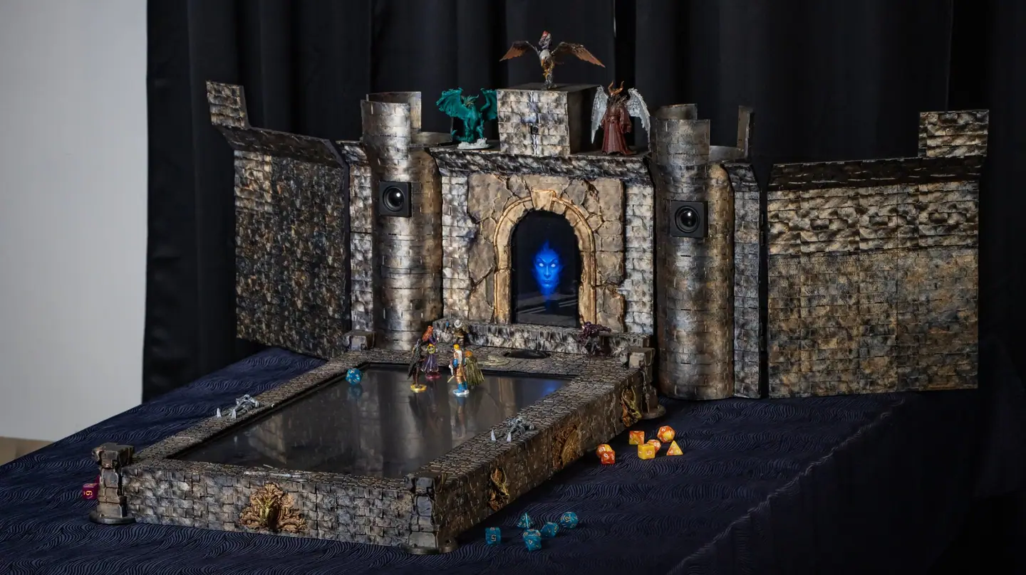 Front view of the whole Doungim console, with miniatures on the towers and dice on the table