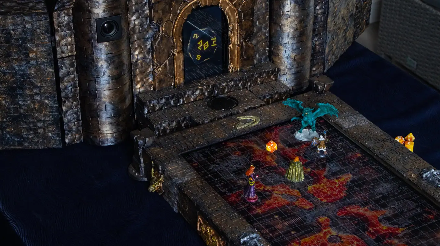 The Doungim gate unit with a twenty sided die on its screen, behind a lava map with miniatures